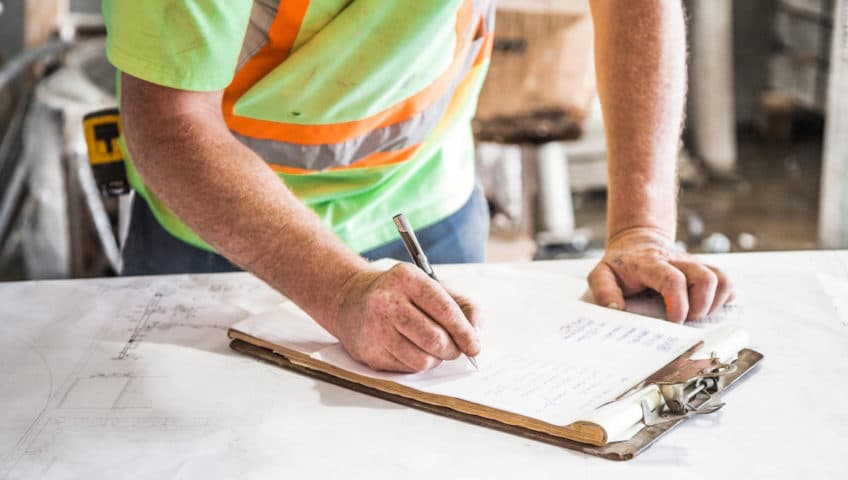 Construction worker reviewing plans