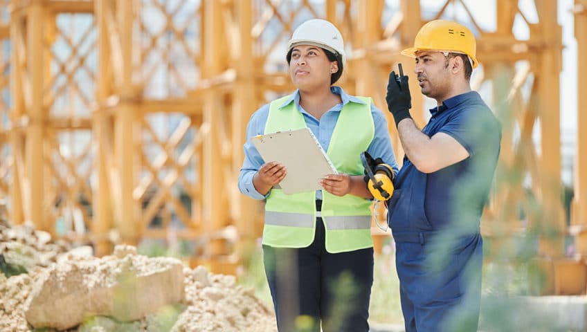 Construction workers reviewing safety protocols on a job site